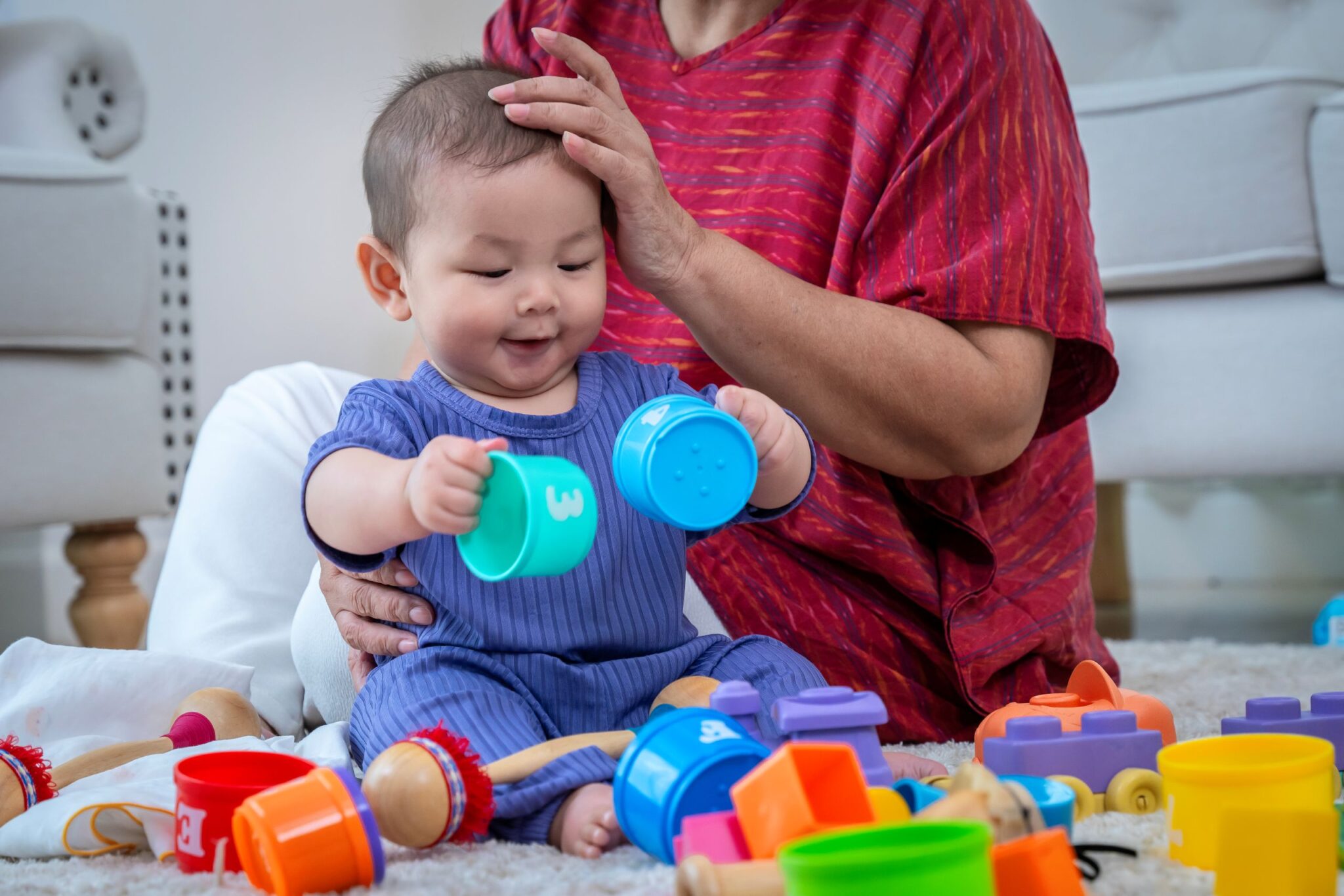 a-woman-and-a-baby-are-playing-with-toys-on-a-carp-2025-03-15-09-59-39-utc