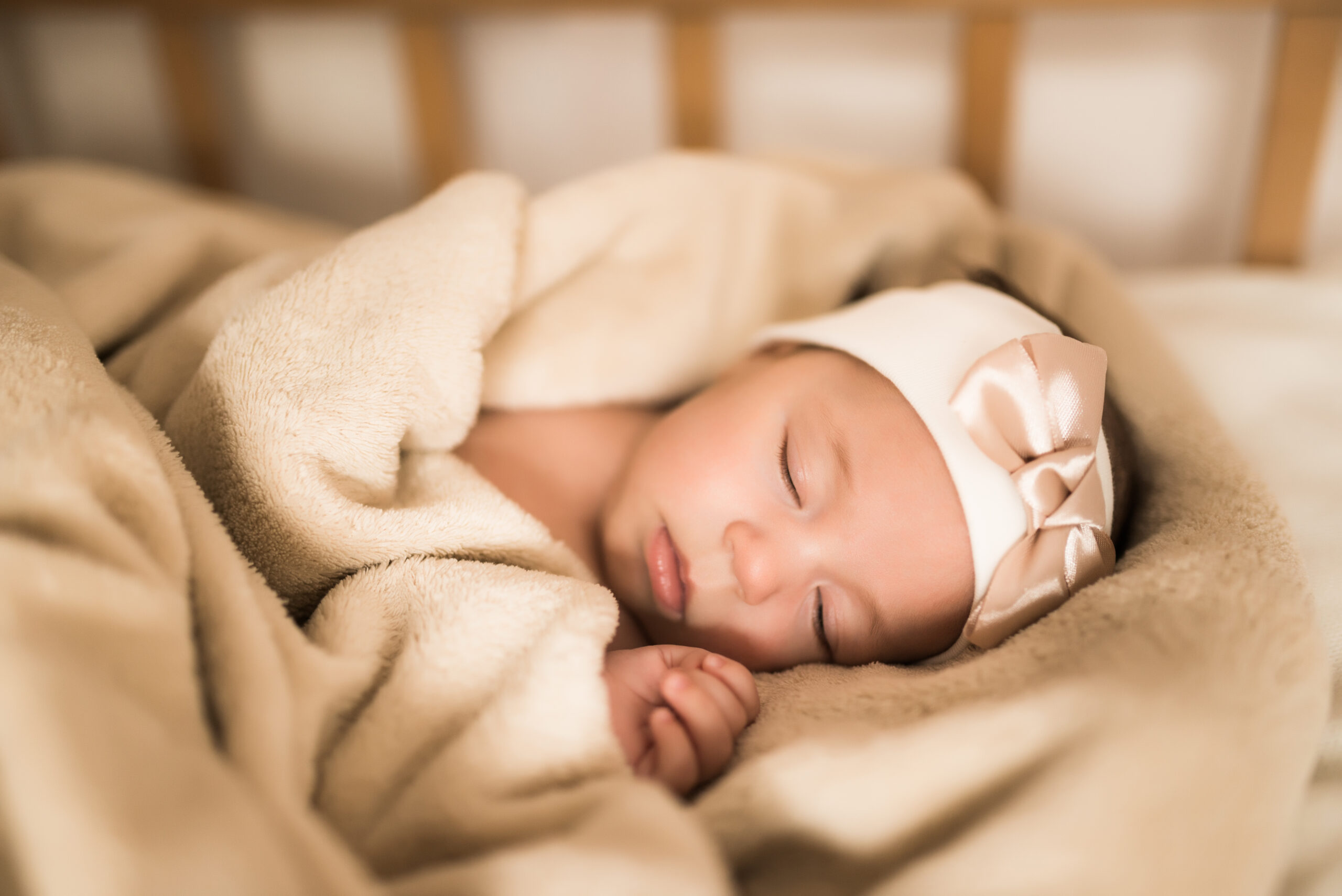 Newborn baby sleeping sweetly in the crib