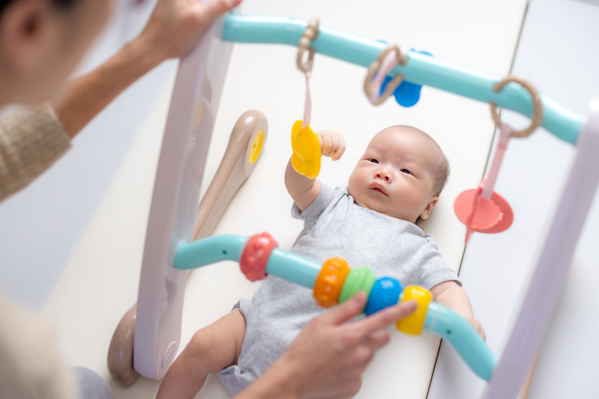mom-play-baby-gym-with-her-newborn-baby-2025-03-25-15-30-25-utc