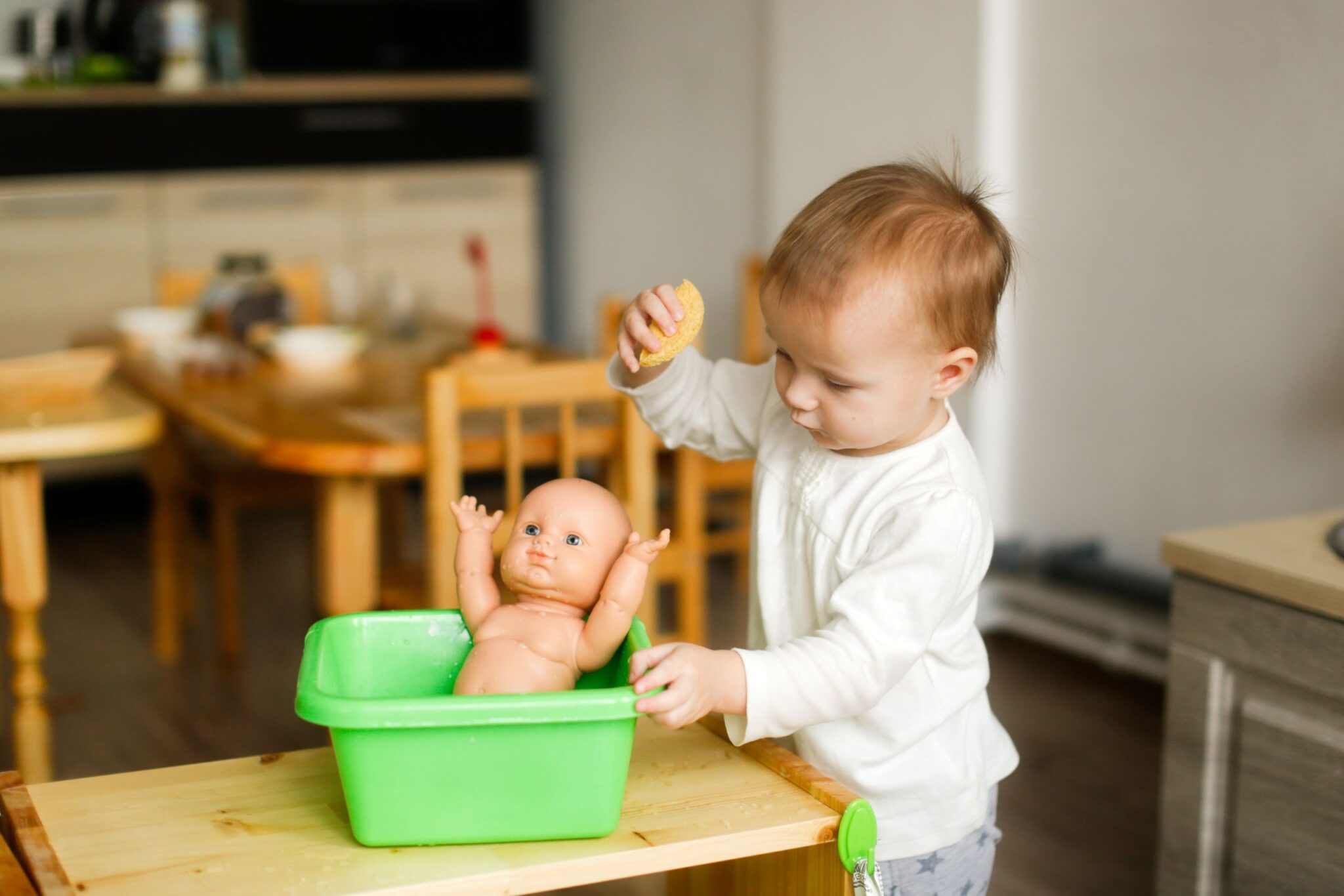 toddler-child-bathes-a-toddler-doll-in-a-basin-of-2024-10-23-10-23-03-utc